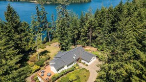 A house with a sloped roof, surrounded by dense forest and a lake. - New Listing! Amazing Lakefront 4 Bedroom 4 1/2 Bath,Sleeps 10, w/ Bonus room,Incredible Views,Dock (Florence)