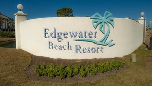 A sign for Edgewater Beach Resort with a palm tree logo.