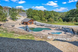 Relax by the pool and unwind in the hot tub, surrounded by lush greenery.
