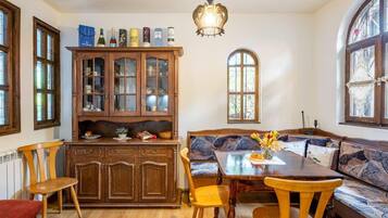 A cozy dining area with a wooden cabinet, a bench, and a table.