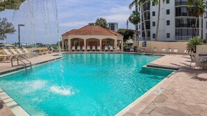 A swimming pool with lounge chairs and a covered pavilion. - GRAND EXECUTIVE 3B/3B WATERSIDE 246 ISLAND CONDO (Fort Myers Beach)