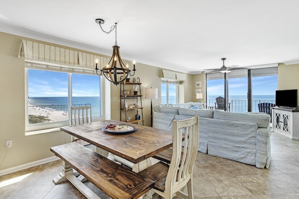 Enjoy meals with a view at this room's dining table, overlooking the beach.