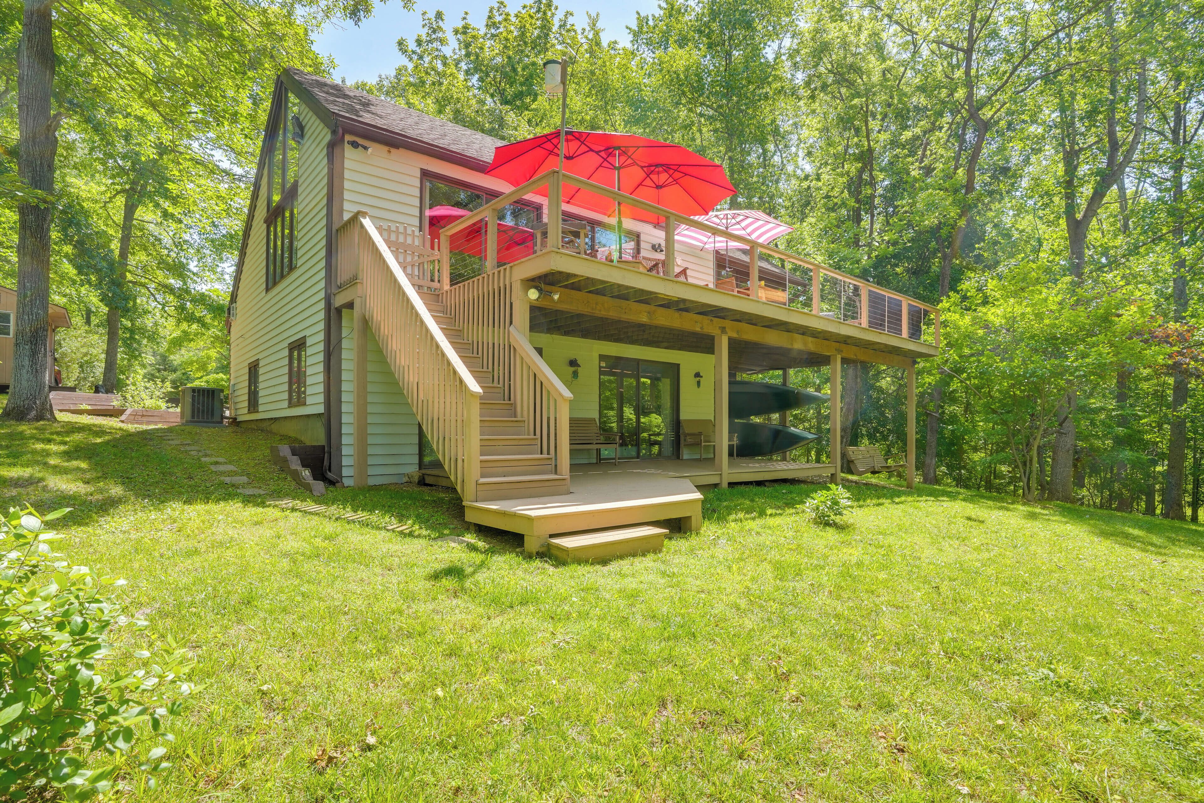 A two-story house with a deck and outdoor seating area.