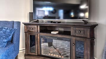 A dark wooden entertainment center with a flat-screen TV mounted above it.