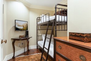 A bunk bed room with a television, a desk, and a dresser. - Charlie Rentz: Luxury Ski-In/Out, BC Village, Sleeps 8, 3 King Beds, AC, Walk to Everything (Beaver Creek)
