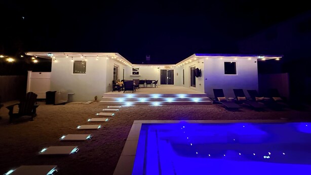 A modern house with a pool, outdoor seating, and string lights. - Casa Azul, Key Largo, Home w Private Pool & Dock (Key Largo)