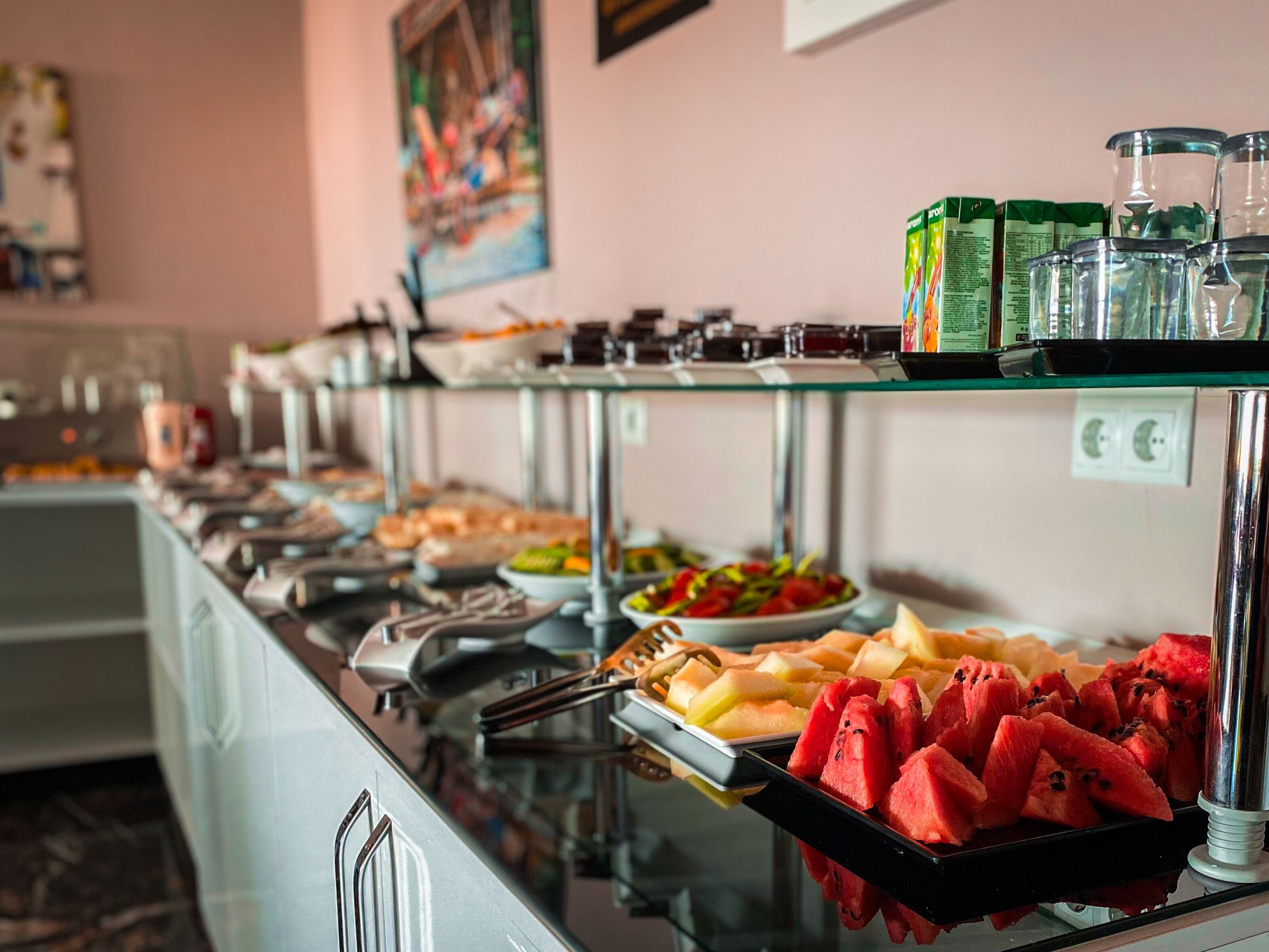 A buffet with various food items and beverages.