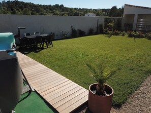 Enjoy outdoor dining and social gatherings on the deck with a grill and comfortable seating.