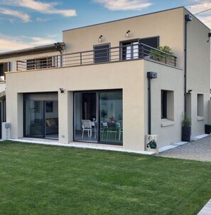Enjoy dining or relaxation in the spacious outdoor area with a well-maintained lawn and patio.