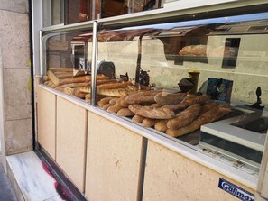A bakery display case with various types of bread.