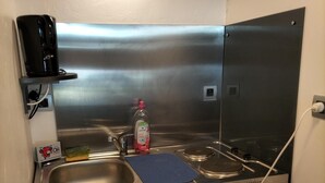 A compact kitchen with a stainless steel sink, a coffee maker, and a small refrigerator. - Studio near the beach (Criel-sur-Mer)