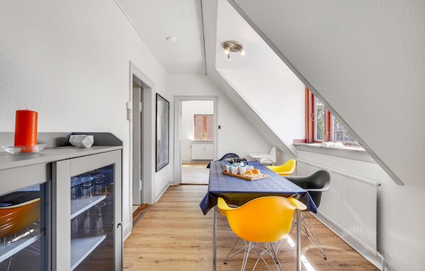 A dining area with a table set for two, a red candle, and a window with a view. - Awesome apartment in Otterup with WiFi (Otterup)