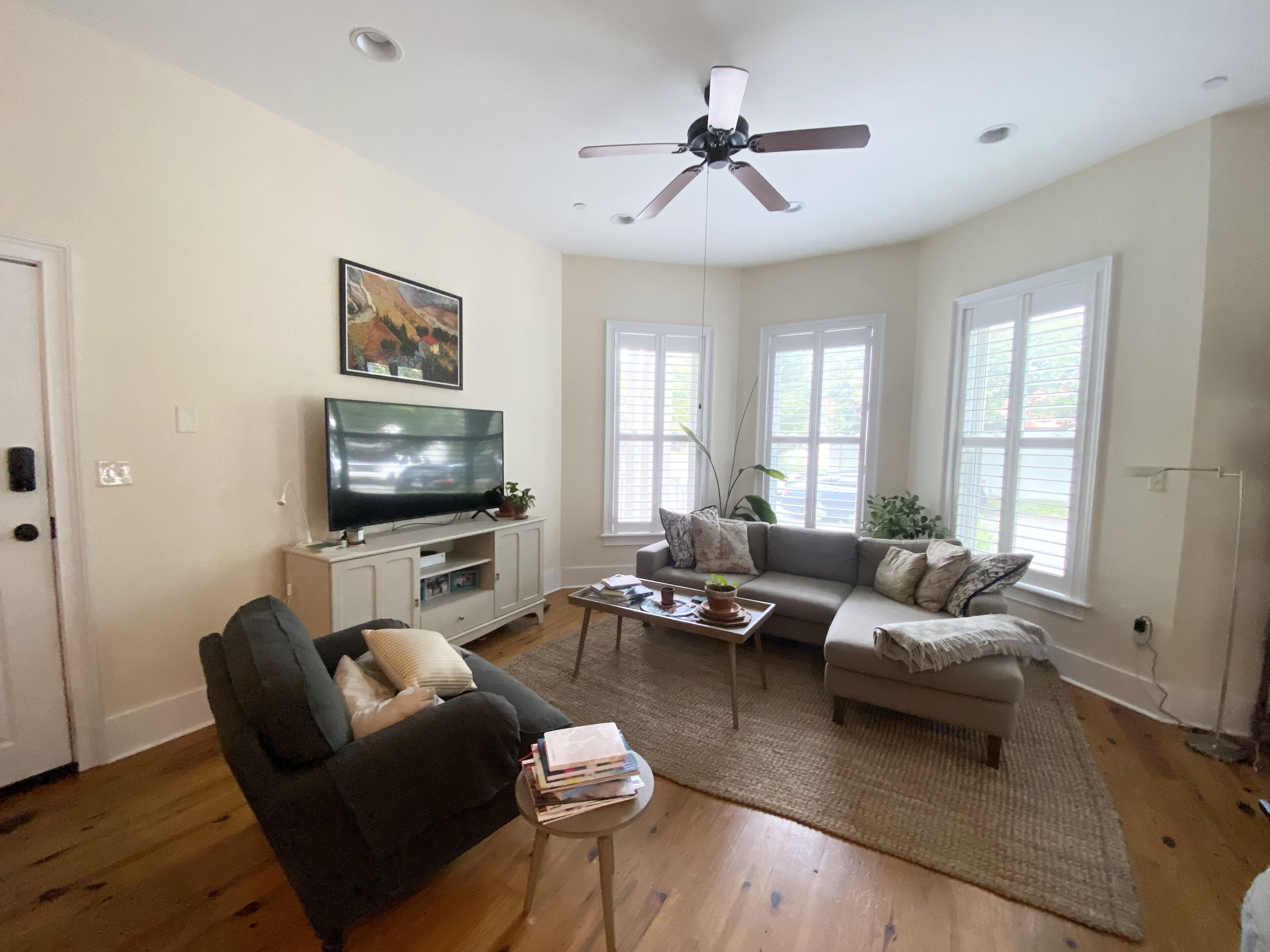 A living room with a television, sofa, and coffee table.