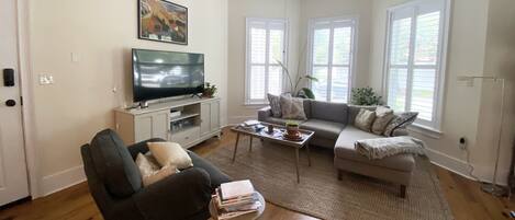 A living room with a television, sofa, and coffee table.