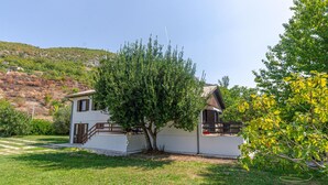 A two-story building with a white exterior, a balcony, and a tree in front. - 3 bedroom lovely home in Blato na Cetini (Blato na Cetini)