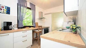 A compact kitchen with a wooden countertop, a coffee maker, a sink, and a window with curtains. - 3 bedroom lovely home in Blato na Cetini (Blato na Cetini)