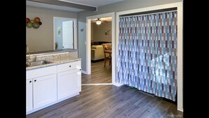 A kitchen with white cabinets, a granite countertop, and a wooden floor. - Cozy modern 4 bedroom, 10 min walk to beach & sunset (Roscommon)