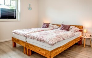 Cozy retreat with a wooden bed, floral bedding, and a bedside table.
