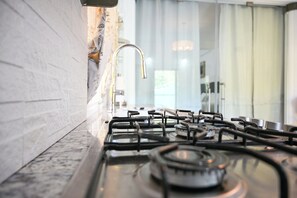 Fridge, microwave, stovetop, coffee/tea maker