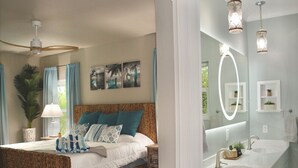 A bedroom with a bed, a nightstand, a lamp, and a ceiling fan. - Luxury Island Escape @ Palm Tree Villa: Private Rooftop Deck & Saltwater Pool (Bookelia)