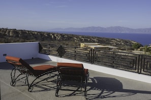 Relax on the rooftop with a clear view of the surrounding landscape from this outdoor space.