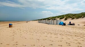 A sandy beach with portable toilets and a tent set up for camping. - 3 bedroom beautiful home in Bredene (Bredene)