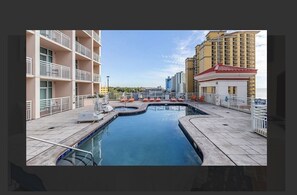 Relax by the pool surrounded by a spacious deck and lounge chairs.