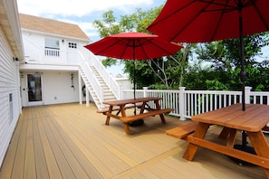Enjoy a meal on the deck with a picnic table and comfortable seating under the shade of two umbrellas.