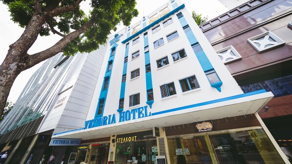 A hotel with a prominent sign, multiple windows, and a modern facade. - Victoria Hotel, a NuVe Group Collection (Singapore)