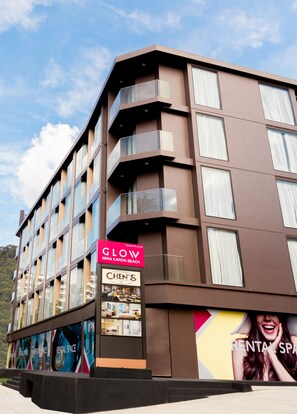 A modern multi-story building with a sign for "GLOW MIRRA KARON BEACH" and "CHEN'S" restaurant. - GLOW Mira Karon Beach (Karon)