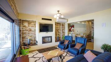 Family Apartment, Multiple Bedrooms, Sea Facing (Maritinas Stone Apartment On The) | Living area | 21-inch TV with cable channels, fireplace