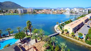 A coastal hotel with a swimming pool, beachfront view, and a bridge connecting to the mainland. - Villa Luna with private pool near the beach for 6 persons, AC, WiFi (Alcudia)