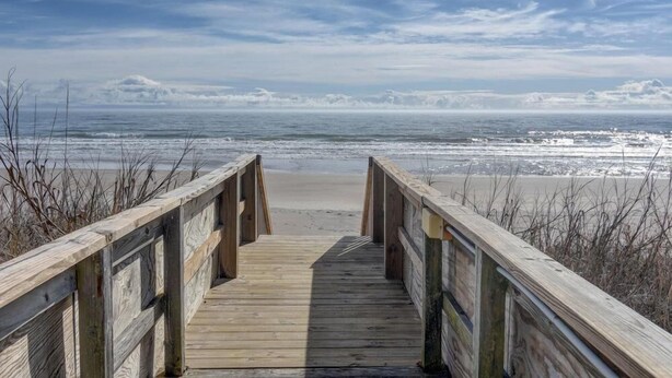 A wooden boardwalk leading to a beach with a clear view of the ocean. - Turtle Cove 134 | Private Community Pool and Beach Access (Surf City)