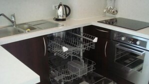 A kitchen with a built-in dishwasher, a sink, and an oven. - Modern 1-Bed Apt near Cannes Seafront & Pool - 1753 (Cannes)