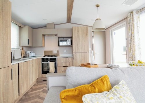 Modern, stylish and spacious 12ft-wide caravan with one double and one twin.