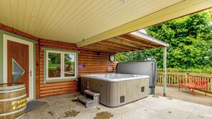 A wooden cabin with a hot tub, a wooden deck, and a covered patio area. - 1 bedroom accommodation in Haswell, Nr Durham (Haswell, Nr Durham)