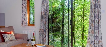 Timber lodge set in an elevated position with views of the lake.