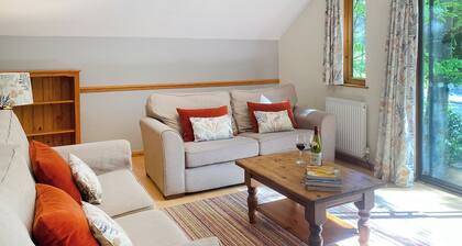 Timber lodge set in an elevated position with views of the lake.