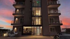 A multi-story hotel with balconies, a reception area, and a visible sign reading "Angel Saranda Palace". - Angel Saranda Palace (Sarandë)