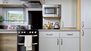 Fridge, oven, stovetop, toaster - 12ft-wide caravan with two twin. (Milford-on-Sea, Nr Lymington)