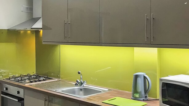 A kitchen with a gas stove, stainless steel sink, and a microwave. - Kinclaven (No Hot Tub) (Cargill)