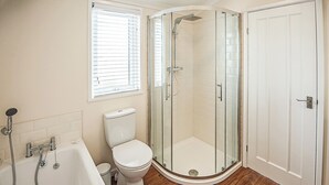 A bathroom with a glass-enclosed shower, a bathtub, and a toilet. - Contemporary lodge furnished to a very high standard. (Tunstall, Nr Hull)