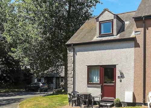 This silver cottage features an open kitchen, dining room, and living room.