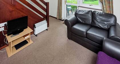 This silver cottage features an open kitchen, dining room, and living room.