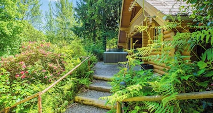 Timber lodge set in an elevated position with views of the lake.