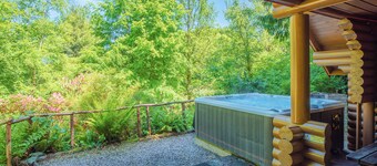 Timber lodge set in an elevated position with views of the lake.