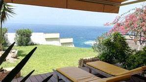 A deck with two lounge chairs facing a view of the ocean. - Costa Adeje Holiday Apartment (Adeje)