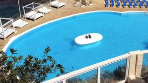 A pool with lounge chairs and a view of the ocean. - Costa Adeje Holiday Apartment (Adeje)