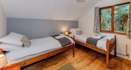 Timber lodge set by the lake with one double and one twin.
