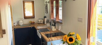 Shepherd’s Hut with an open plan design with king-size bed.